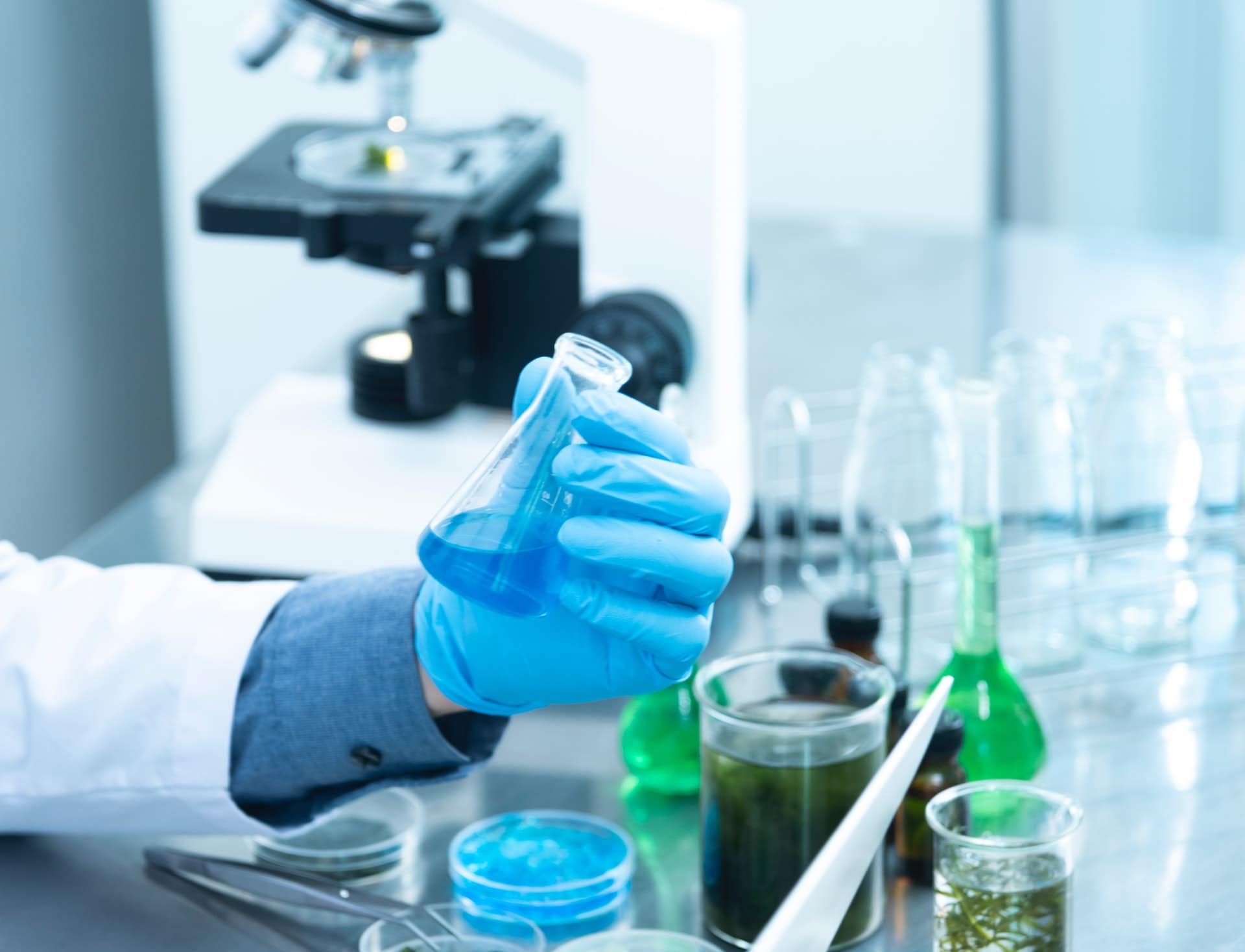 man-holding-vial-of-blue-liquid_home-page-banner-background-1-chembase-academy